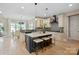 Modern kitchen with white cabinets, an expansive island, and pendant lighting at 4023 Randolph Rd, Charlotte, NC 28211