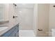 Bathroom with walk-in shower and blue vanity at 4023 Randolph Rd, Charlotte, NC 28211
