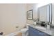 Modern powder room with blue vanity and gray countertop at 4023 Randolph Rd, Charlotte, NC 28211