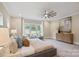 Bright bedroom featuring a large window and ceiling fan at 4023 Randolph Rd, Charlotte, NC 28211