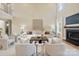 Open living area with high ceilings, a fireplace, and ample natural light at 4023 Randolph Rd, Charlotte, NC 28211