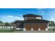 Three-car garage with dark siding and wooden garage doors. Pool is visible in the background at 628 Wisteria Vines Trl # 6, Fort Mill, SC 29708