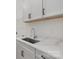 Well-appointed laundry room with white shaker cabinets and quartz countertops at 166 Windy Dell Dr, Tega Cay, SC 29708