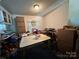A cluttered dining area with a table and chairs, boxes, and various items at 100 Springs Ct, Stony Point, NC 28678