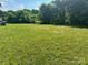 Open grassy area behind the mobile home at 100 Springs Ct, Stony Point, NC 28678
