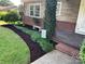 Landscaped front yard with mulch beds and a charming bench at 810 Hampton St, Shelby, NC 28152
