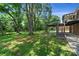 Spacious backyard with large trees and a deck at 810 Hampton St, Shelby, NC 28152