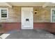 White front door with sidelights and brick accents at 810 Hampton St, Shelby, NC 28152