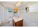 Bathroom with tiled walls and wood vanity at 810 Hampton St, Shelby, NC 28152