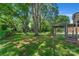 Large backyard with lush green grass and mature trees at 810 Hampton St, Shelby, NC 28152