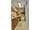 Clean and functional kitchen, featuring wood cabinets and tile floors at 19831 Henderson Rd # D, Cornelius, NC 28031