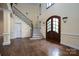 Two-story entryway with hardwood floors, a grand staircase, and double doors at 2708 Chilton Pl, Charlotte, NC 28207