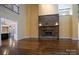 Living room featuring hardwood floors, a stone fireplace, and high ceilings at 2708 Chilton Pl, Charlotte, NC 28207