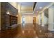 Spacious living room featuring hardwood floors, a stone fireplace, and a high ceiling at 2708 Chilton Pl, Charlotte, NC 28207