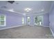 Large bedroom with balcony access and plush carpeting at 2708 Chilton Pl, Charlotte, NC 28207