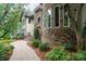 Stone and stucco house exterior with a curved walkway and landscaping at 2708 Chilton Pl, Charlotte, NC 28207