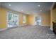 Bright bonus room with neutral carpeting and built-in entertainment center at 2708 Chilton Pl, Charlotte, NC 28207