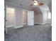 Bright bedroom with grey carpet, ceiling fan and walk-in closets at 2708 Chilton Pl, Charlotte, NC 28207