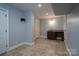 Finished basement with wet bar and neutral-toned tile flooring at 2708 Chilton Pl, Charlotte, NC 28207