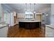 Modern kitchen with a large island, white cabinets, and hardwood floors at 2708 Chilton Pl, Charlotte, NC 28207