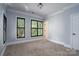 Serene bedroom with neutral carpeting and black window shutters at 2708 Chilton Pl, Charlotte, NC 28207