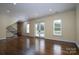 Spacious living room featuring hardwood floors and French doors leading to the backyard at 2708 Chilton Pl, Charlotte, NC 28207