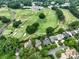 Aerial view of house on golf course with city skyline in background at 2708 Chilton Pl, Charlotte, NC 28207