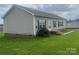 Tan mobile home with landscaping and deck at 200 Olin Loop, Olin, NC 28660