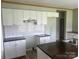 White kitchen cabinets, dark countertops, and an island at 200 Olin Loop, Olin, NC 28660