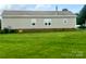 Tan mobile home with a spacious backyard at 200 Olin Loop, Olin, NC 28660