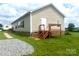 Tan mobile home with a deck and stone base at 200 Olin Loop, Olin, NC 28660