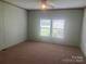 Bright bedroom with neutral walls, carpet, and a ceiling fan at 200 Olin Loop, Olin, NC 28660