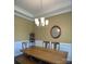 Bright dining room with chandelier and wood table at 2044 Sweet William Dr, Harrisburg, NC 28075