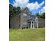 Side view of a two-story brick home with a landscaped lawn at 2044 Sweet William Dr, Harrisburg, NC 28075