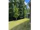 Spacious backyard with mature trees and lush lawn at 2044 Sweet William Dr, Harrisburg, NC 28075