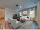 Bright and airy living room with hardwood floors and neutral decor at 2011 Merida St, Charlotte, NC 28214