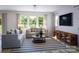 Relaxing living room with large windows and striped rug at 1008 Briar Well St, Mint Hill, NC 28227