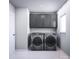 Laundry room with washer, dryer and dark cabinets at 1008 Briar Well St, Mint Hill, NC 28227