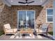 Cozy patio with brick wall and comfortable seating at 1008 Briar Well St, Mint Hill, NC 28227