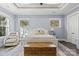 Spacious bedroom with light walls, hardwood floors and a cozy seating area at 001 Beatties Ford Rd, Huntersville, NC 28078