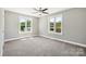 Well-lit bedroom featuring two windows and ceiling fan at 2120 Old Salisbury Concord Rd, Concord, NC 28025