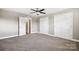 Bright bedroom featuring carpet, ceiling fan and multiple closets at 2120 Old Salisbury Concord Rd, Concord, NC 28025