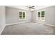 Bright bedroom with two windows, ceiling fan, and carpeted floor at 2120 Old Salisbury Concord Rd, Concord, NC 28025