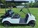 Side view of white golf cart with black seats and custom rims at 220 Roberts Ridge Rd # H13, Mount Gilead, NC 27229