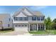 Two-story home with gray siding, stone accents, and a two-car garage at 119 Stonewater Dr # 22P, Red Cross, NC 28129