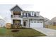 Two-story home with stone and gray siding, balcony, and a two-car garage at 1465 Ardmore Dr # 237, Sherrills Ford, NC 28673