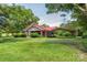 Brick ranch house with red metal roof, covered carport, and landscaped yard at 2491 Highway 274 Hwy, Cherryville, NC 28021