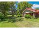 Brick house with red metal roof, side yard, and mature trees at 2491 Highway 274 Hwy, Cherryville, NC 28021