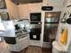 Galley kitchen with double sink, stove, microwave, and refrigerator at 332 Mount View Ln, New London, NC 28127