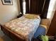 Simple bedroom with a double bed, nightstand, and wood floors at 108 Meadowview Cir, New London, NC 28127